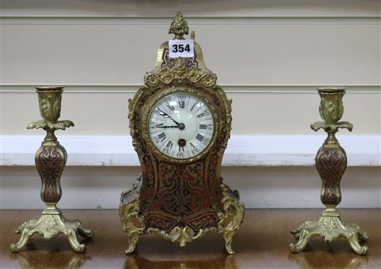 An early 20th century red boullework mantel timepiece, with a pair of similar candlesticks clock 30cm candlesticks 20cm